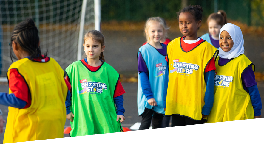 Group of girls taking part in  Shooting Stars girls' football programme