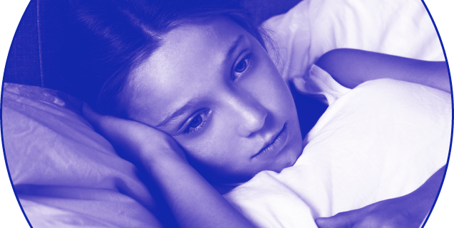 Unhealthy young girl looking sad in bed